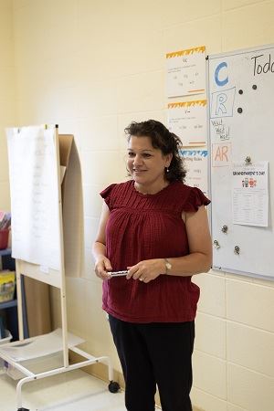 Tara standing in her classroom